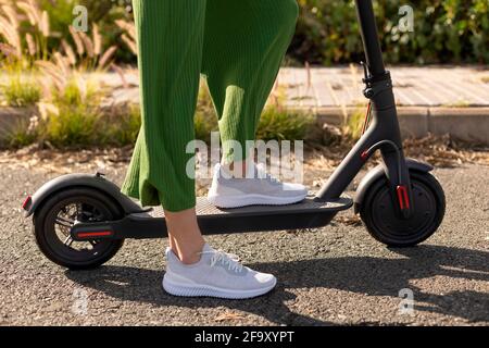 An unrecognisable woman on an electric scooter Stock Photo