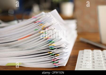 Lot of documents fastened with multicolored paper clips lying on table closeup Stock Photo