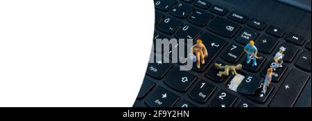 Mini Workers working on keyboard, under construction concept Stock Photo