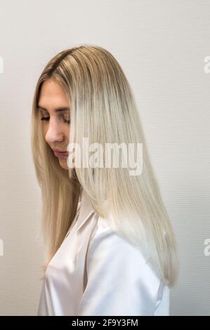 Portrait of a blonde woman with extended hair Stock Photo