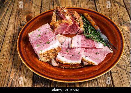 Smoked pork Slab Bacon meat slices on a rustic plate. wooden background. Top view Stock Photo