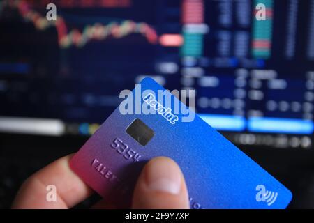 Berlin, Germany - April 21, 2021: Man holding Revolut debit card in hand. Revolut is a fast, simple, and easy way to buy, sell, and hold cryptocurrenc Stock Photo