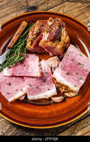 Smoked pork Slab Bacon meat slices on a rustic plate. wooden background. Top view Stock Photo
