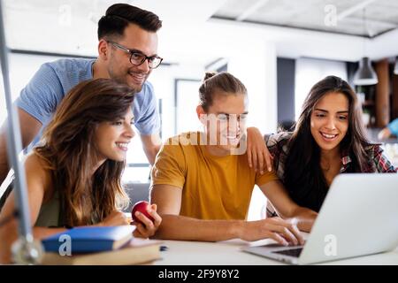 Multiracial young people enjoying group study at table. Stock Photo