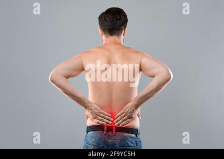 Man holding his hands behind his back, back view Stock Photo
