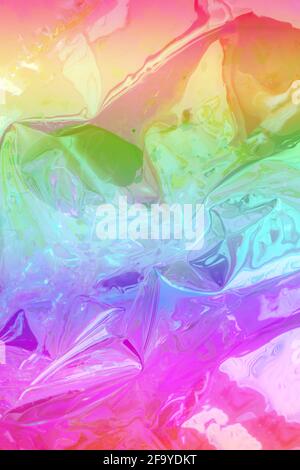 Abstract background shiny crumpled hologram with sparkles. Trendy neon textured background. Template for creative holiday design. Vertical frame Stock Photo