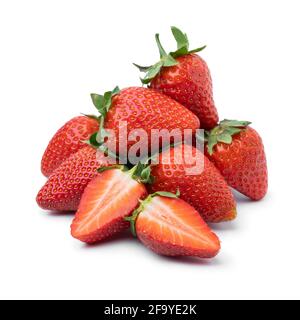 Heap of fresh picked whole and half ripe red strawberries isolated on white background Stock Photo