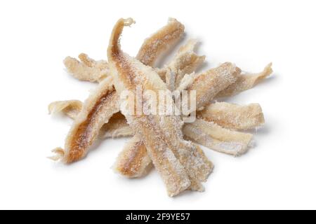 Heap of dried and salted cod fillets close up isolated on white background Stock Photo