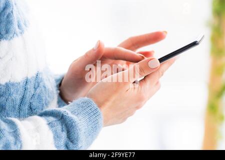 Female hands using mobile phone close up Stock Photo