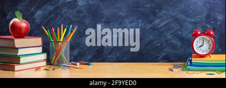 Apple On Stack Books With Pencils And Alarm Clock - Back To School Stock Photo