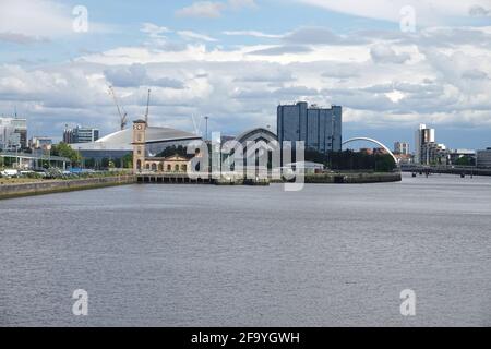 The Glasgow, Scotland West End cityscape from River Clyde is shown from the Partick area during a partly cloudy, afternoon day. Stock Photo