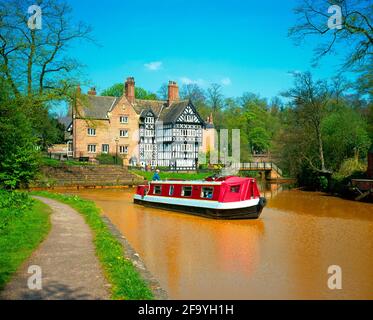 UK, England, Salford, Worsley, The Packet House, Bridgewater canal, with natural iron stained water, and canal boat Stock Photo