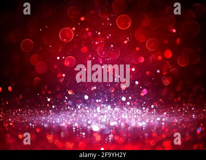 Silver Glitter Sparkling In Red Blurred Background Stock Photo