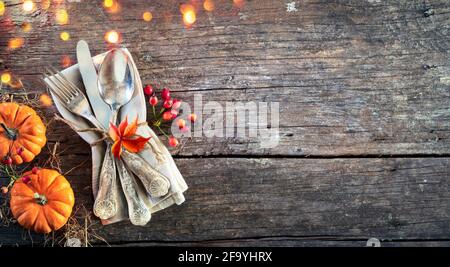 Thanksgiving Place Setting - Rustic Table With Silverware And Pumpkins Stock Photo