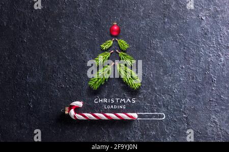 Christmas Card - Loading Concept - Tree And Candy Canes On Black Stone Stock Photo