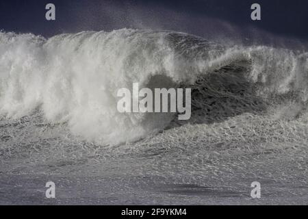 Stormy breaking sea wave against dark sky. Northern portuguese coast during winter. Stock Photo