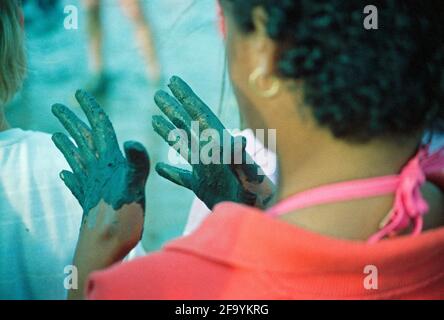 teenager with dirty hands on a mudflat hiking tour, September 1987, Wangerooge Island, East Friesland, Lower Saxony, Germany Stock Photo