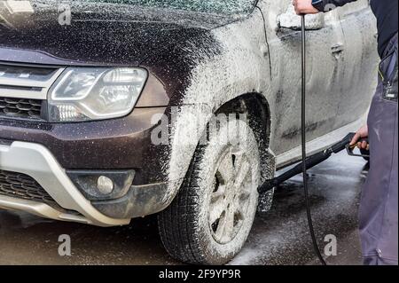 Kaliningrad region, Russia, March 1, 2020. A man washes his car. A man at a car wash. A Renault in foam at a car wash. Stock Photo