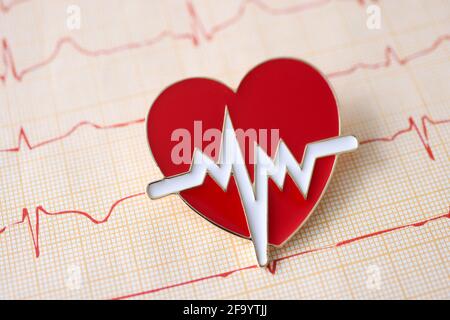 Result of electrocardiogram with icon lies on table Stock Photo