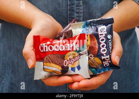 Tambov, Russian Federation - October 30, 2020 Different tastes Choco-Pie snack cakes in woman hands. Stock Photo