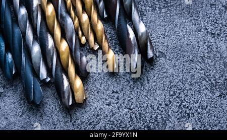 Set of drill bits on grey background Stock Photo
