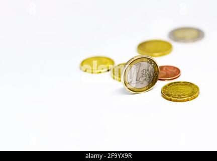 One euro coin standing together with various coins isolated on a white background. Economics and finance. European union currency Stock Photo