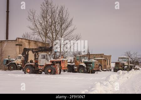 old rusty abandoned tractors in winter Stock Photo