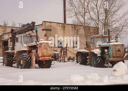 old rusty abandoned tractors in winter Stock Photo