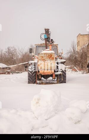 old rusty abandoned tractors in winter Stock Photo