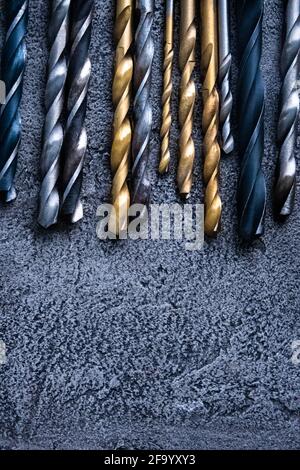 Different sizes drill bits on grey background with copy space Stock Photo
