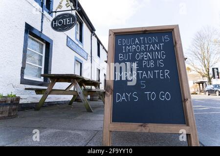 Denholm, Scottish Borders, Scotland, UK. 21 April 2021. Blackboard sign outside theAuld Cross Keys Inn hotel and pub in Denholm village reminding public that the pub is more important than education with 5 days to go until it can re-open when hospitality lockdown rules are relaxed in Scotland.   Iain Masterton/Alamy Live News Stock Photo