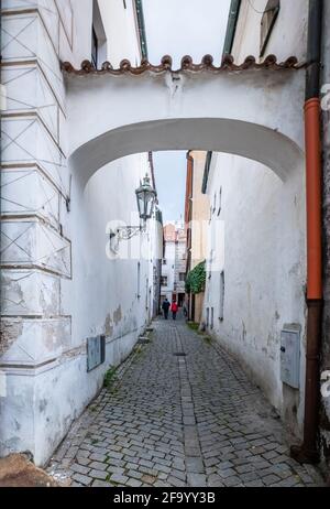 Ancient white arch over narrow street in Cesky Krumlov Stock Photo