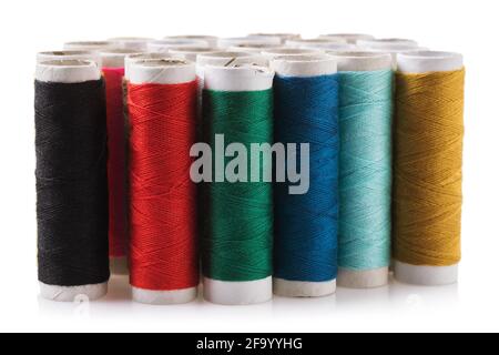 Set of spools with multicolored threads isolated on white background. Stock Photo