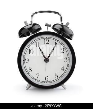 Black metall vintage alarm clock isolated on white. Front view. Stock Photo