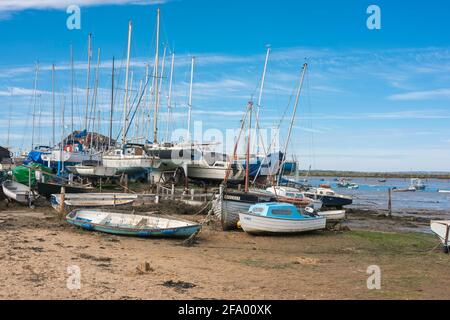 Essex coast, view of boats and yachts resting at low tide along the River Blackwater estuary at West Mersea on the Essex coast, England, UK Stock Photo