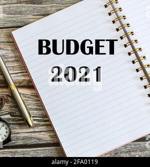 Top view of a pen with Budget 2021 written on a notebook. Stock Photo