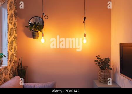 Cozy retro living room modern interior with colorful furniture, Hanging light bulb and modern style decoration closeup Stock Photo