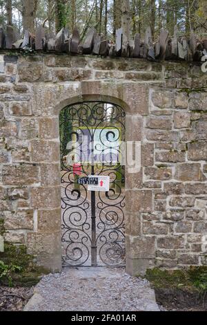 An ornate iron gate gives access to the Wales Coast Path and Glan Faenol wildlife and woodland walk. Stock Photo