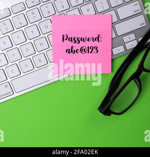 Password written on a pink sticky note. Stock Photo