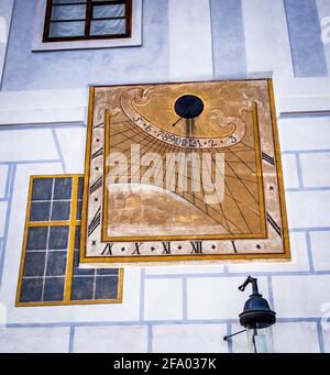 Anchient painted sun clock on the wall in Cesky Krumlov Stock Photo