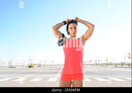 Female athlete getting her hair ready Stock Photo