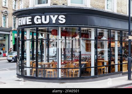 Five Guys burger restaurant at King's Cross, London, UK, closed  during the coronavirus lockdown in April 2021, London, UK Stock Photo