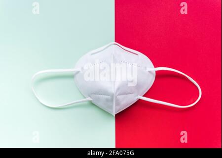 Disposable mask with hook, FFP2 with N95 protection to protect yourself and others from Covid-19. protection against the spread of infection.Light red Stock Photo