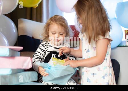 @ young sisters having a lockdown birthday at home. UK Stock Photo