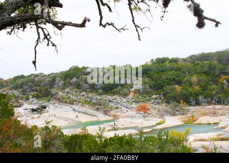 Looking down on Pedernales Falls Texas - tourists walking around the river that flows underground Stock Photo