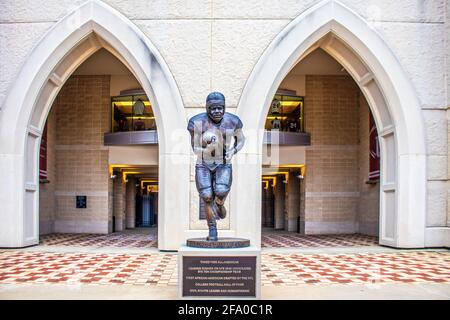 03-26 2021 Bloomington Indiana USA Statue of football player George Taliferro 3-time all-American in front of arched opening to Hoosier Stadium at IU. Stock Photo