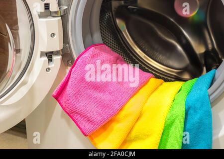 Colorful towels lying in an open washing machine Stock Photo