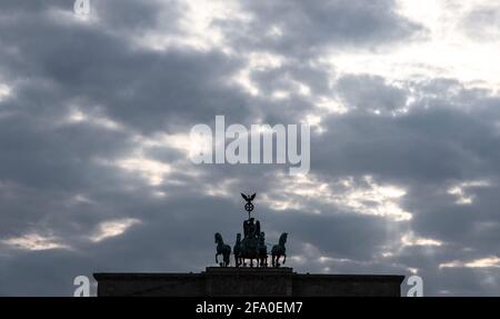 Berlin, Germany. 21st Apr, 2021. Dark clouds can be seen over the Quadriga on the Brandenburg Gate. Credit: Paul Zinken/dpa-Zentralbild/dpa/Alamy Live News Stock Photo