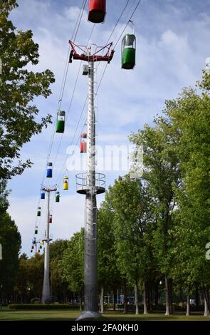 Brightly colored cable cars carry tourists. Running on wires supported by steel pylons, it is the longest cable car route. gondola cabins suspended ca Stock Photo