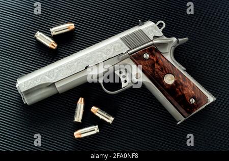 Idaho Falls, Idaho, USA Dec 12, 2001 A nickle plated Colt 45 Mark IV 80 series with custom engraving on the barrel. Stock Photo